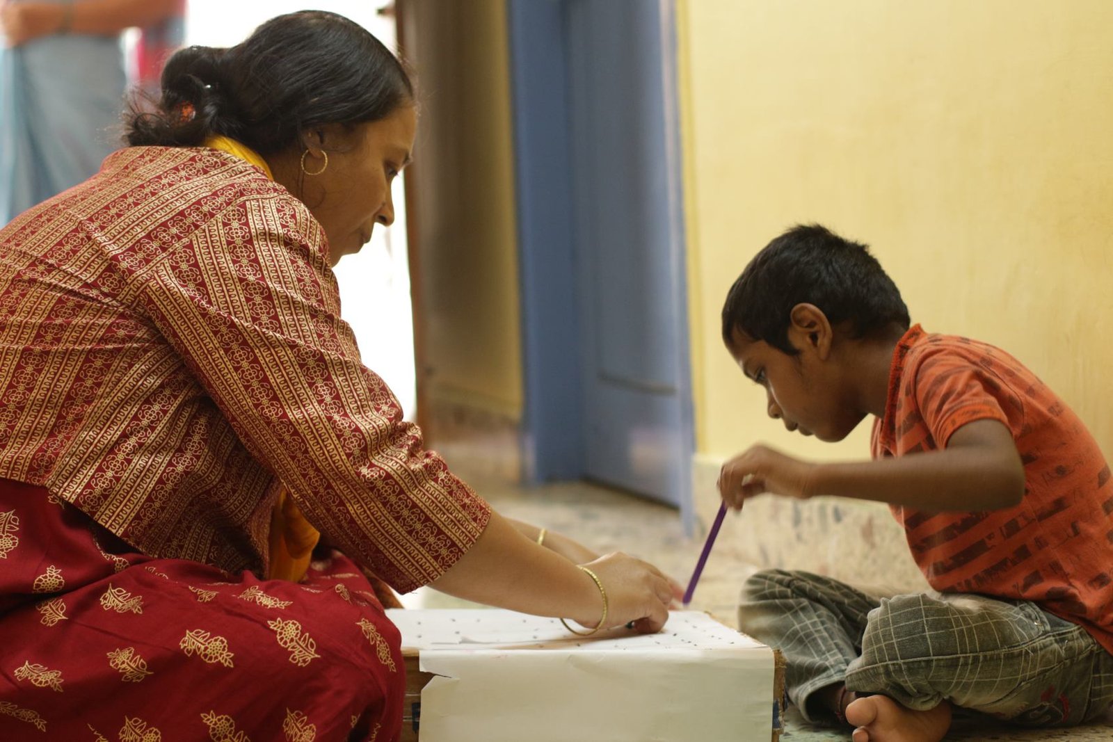 Child learning with a teacher